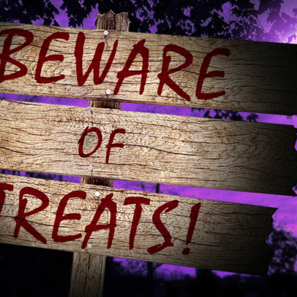 "Beware of Treats" sign on a spooky night